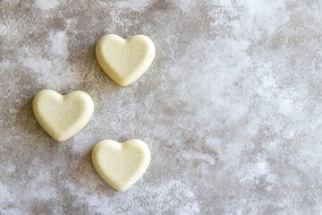 Obraz premium Top view of yellow hearts fashioned from colored paper set against a gray surface, showcasing the trendy colors of 2021