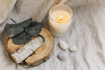 White sage and candle with stones for meditation. Minimalism. Calm and mindfulness.