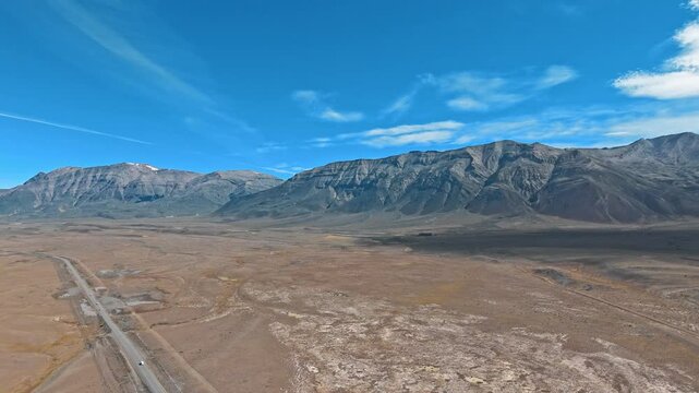 Shadow of the Andes. Discover the awe-inspiring beauty of Argentina's vast pampas and towering Andes mountains in this stunning drone footage. Endless horizons, peaks and a captivating blue sky await.