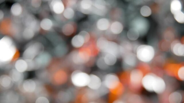 Silver metal background with red flashes. The texture of a blurred and abstract background with a side.