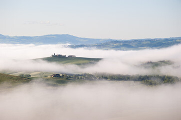 Misty Hills with Farmhouses in Tuscany, Italy