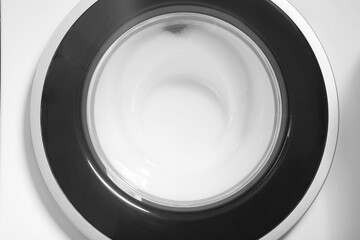 Washing machine with suds as background, closeup