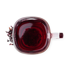 Delicious hibiscus tea in glass cup and dry roselle sepals isolated on white, top view