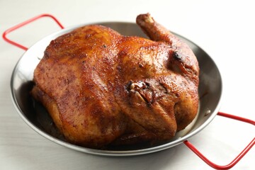 Delicious baked turkey in baking dish on light table, closeup
