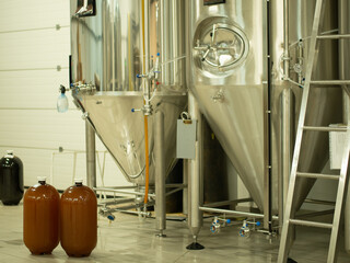 A small industry brewery's brewing tanks in a brewery that produces craft beer