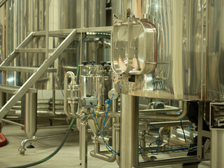 A small industry brewery's brewing tanks in a brewery that produces craft beer