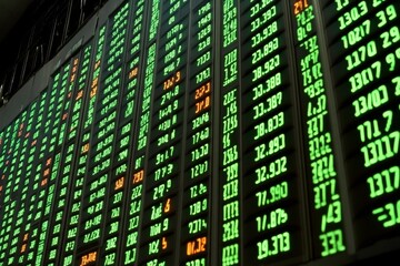 Fototapeta premium Display Board of Stock Market Prices Showing Profits and Losses with Green Digital Signs Indicating Financial Data for Investors and Traders in a Busy Trading Environment