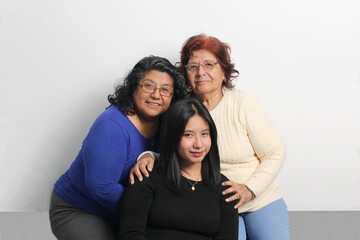Three generations of brown Latina women, grandmother, mom and daughter show their love and support to celebrate Mother's Day