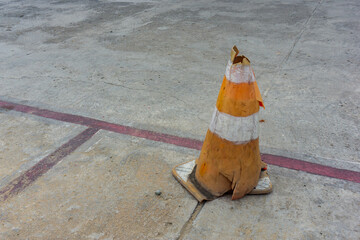 Worn orange traffic cone with copy space