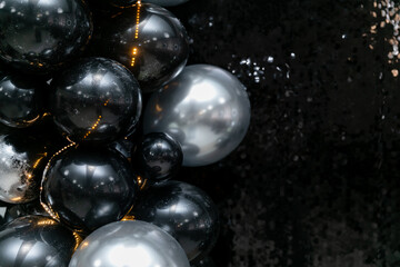 Generated imageLuxurious black and silver balloon arrangement with shimmering sequins and warm fairy lights. A perfect backdrop for elegant parties, New Year's celebrations, and glamorous events.