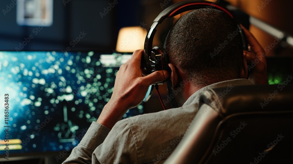 Aufkleber man playing sf space videogame on pc screen, shooting asteroids, putting headphones on. close up of 