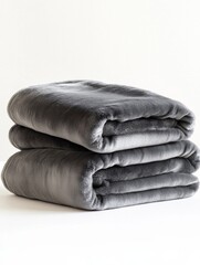 Fototapeta premium Stacked soft gray fleece blankets on white background