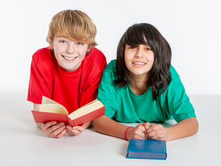 Fototapeta premium Early Teens: Book Friends. A pair of early teenage friends enjoying reading their books.