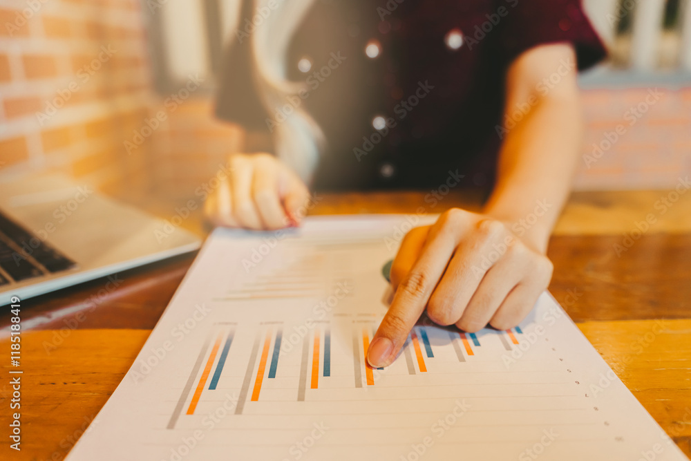 Poster business analysis with charts and graphs on a table with laptop in focus