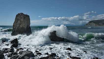 Russia, Sudak. The Republic of Crimea. View of the rocky coast of the Black Sea with waves hitting the rocks.