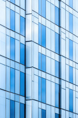 Obraz premium Modern highrise buildings under construction. The facade of an office building or luxury residential complex flats block finished with mirror panels.