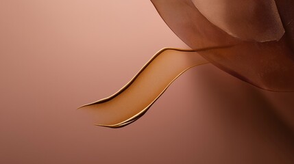 Silky foundation streak with golden undertones on a warm pink background creates a glamorous aesthetic