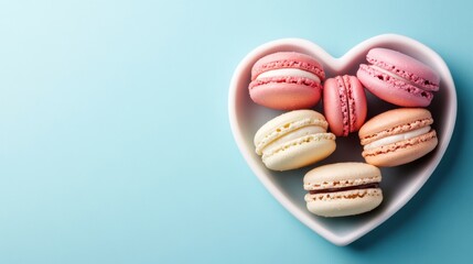 Fototapeta premium a heart shaped plate filled with macarons on a blue background