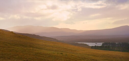 Obraz premium Glenveagh National Park in Donegal Ireland -Spectacular aerial view showcasing lush green valleys and rolling hills beneath a colorful and vibrant sky