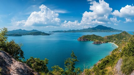 Fototapeta premium A stunning panoramic view of a tropical coastline with lush greenery and serene waters.