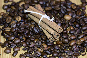 Cinnamon sticks and coffee beans on a wooden table