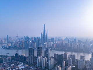 Fototapeta premium Aerial View of Shanghai skyline at sunrise with the Winding Huangpu River