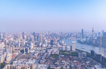 Fototapeta premium Aerial View of Shanghai skyline at sunrise with the Winding Huangpu River