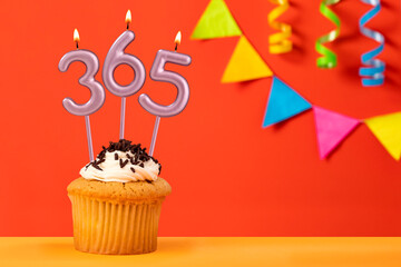 Three candles forming the number 365 - Orange background.