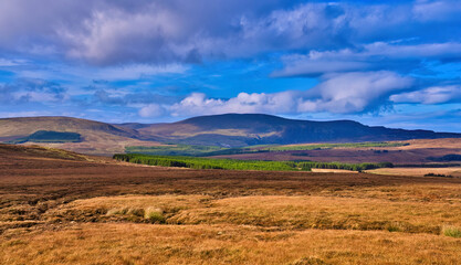 Glenveagh National Park in Donegal Ireland -Spectacular aerial view showcasing lush green valleys and rolling hills beneath a colorful and vibrant sky