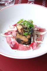 A close-up of a salmon starter dish. Paris, France - January 5, 2025. 