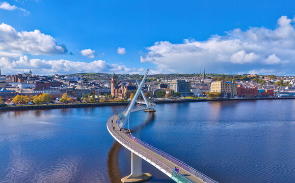 City of Derry aka Londonderry in Northern Ireland aerial view - A Beautiful Cityscape from above by the River Foyle Featuring the Beautiful Pedestrian Peace Bridge