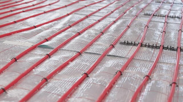 Installation of underfloor heating pipes within a modern building construction project