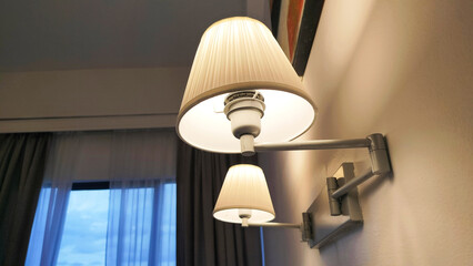 a pair of hotel room lamps. Retro lamp attached to the wall. 