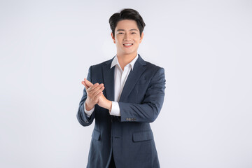 Portrait of young Asian business man posing on white background