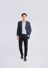 Full body image of a young Asian business man posing on a white background