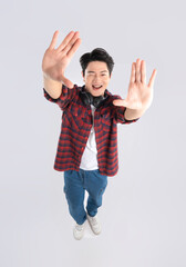 Full body image of young dynamic Asian man posing on white background