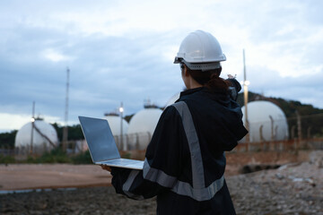 Inspection engineers working with laptops of gas refinery plant and refinery oil factory industry