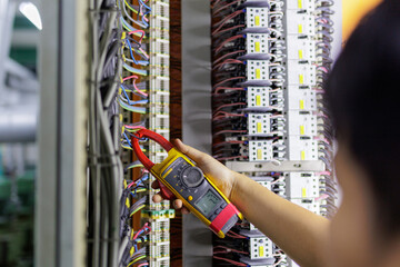 Electrical engineering uses a multimeter to measure the electrical current of wires.