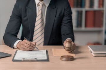 Male lawyer in law office working with icon and adjusting justice and legal concept Male judge in courtroom on wooden table and counsel or lawyer