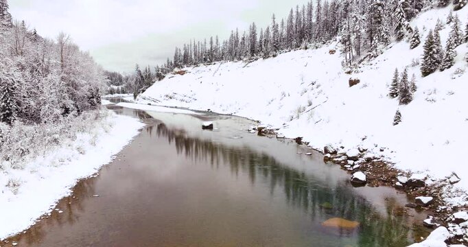 Flathead River and Snowy Forest Aerial Drone Glacier National Park