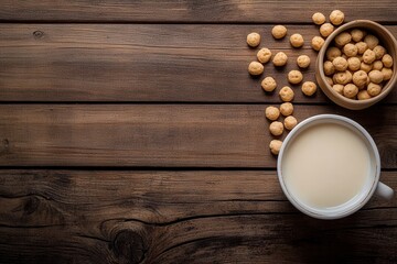Warm milk in a white cup beside a wooden bowl filled with crunchy cereal balls on a rustic wooden table, creating a cozy breakfast scene for morning delight.