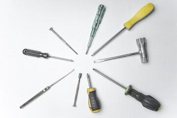 Different old screwdrivers on a white background. Cross, minus and with a rubber handle against electric shock. High quality photo