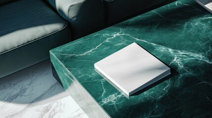 Blank book mockup on green marble coffee table.