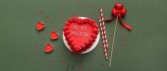 Sweet bento cake and candles on green background. Valentine's Day celebration © Pixel-Shot
