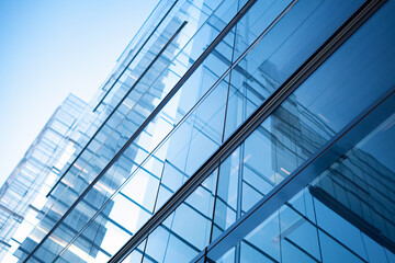 Modern Architectural Design Showcasing Sleek Glass Facade with Reflections Under Clear Blue Sky in Urban Environment
