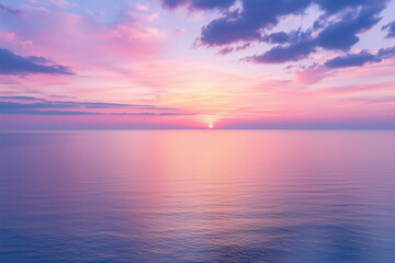 Obraz premium breathtaking sunset over calm ocean, showcasing vibrant pink and purple gradients in sky. serene waters reflect stunning colors, creating peaceful atmosphere