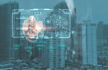 A hand interacts with a futuristic digital interface, overlaying a cityscape, symbolizing...