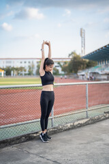 Active healthy asian woman exercising by running, jogging runner sports stadium during the morning healthcare and well being concept