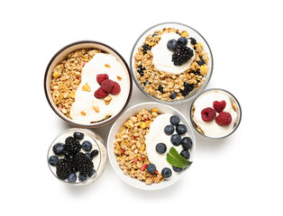 Bowls of tasty granola with yogurt on white background