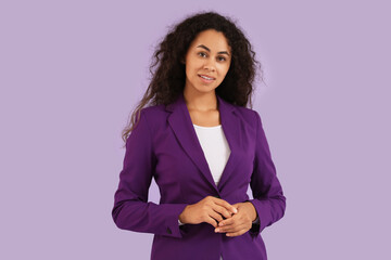 Portrait of beautiful African-American businesswoman on purple background